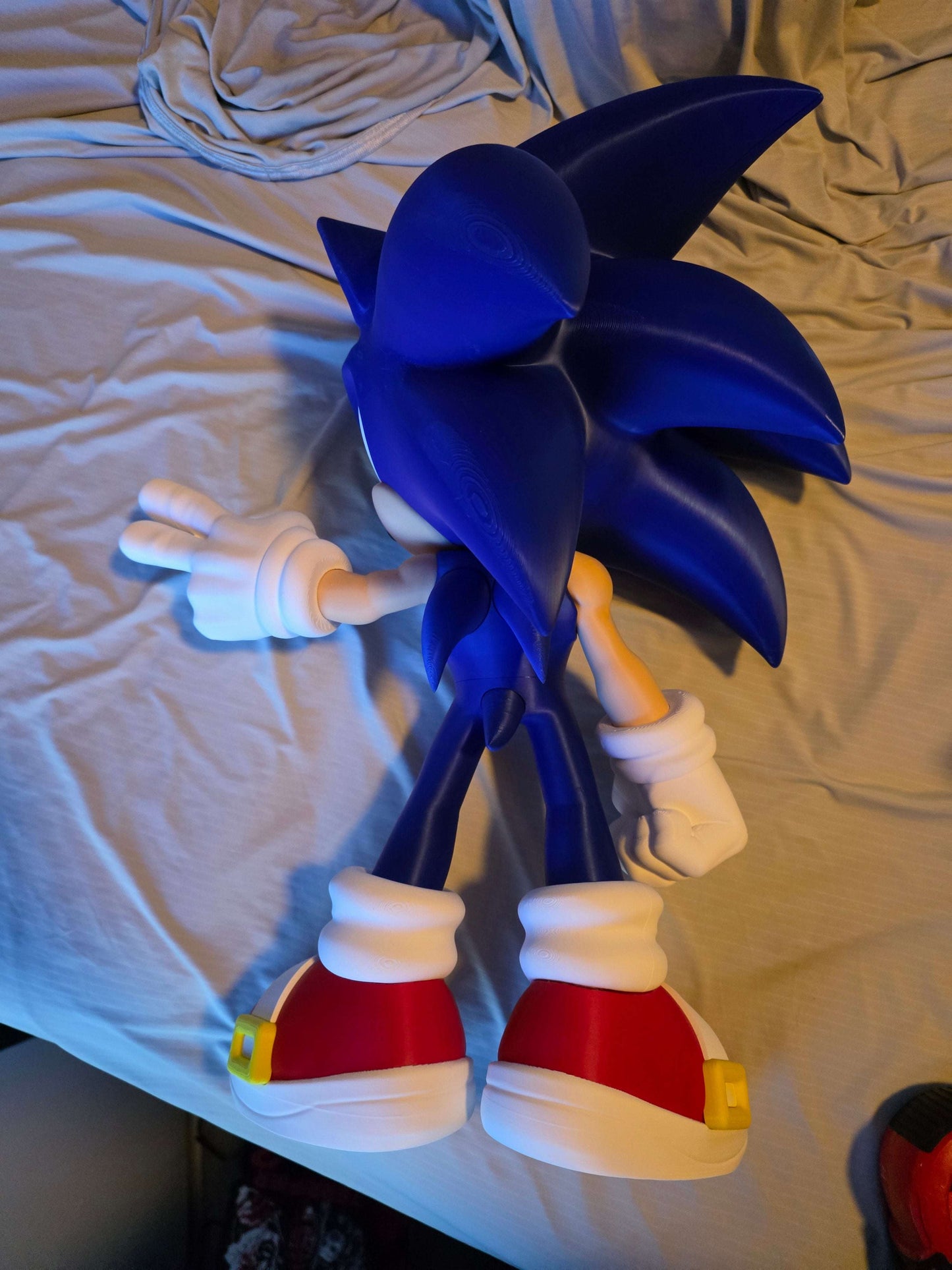 18" tall blue hedgehog figure standing with support under back foot