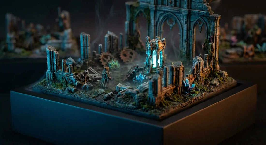 A dramatically lit 3D printed diorama scene with detailed miniature ruins and atmospheric LED lighting on a dark display surface.