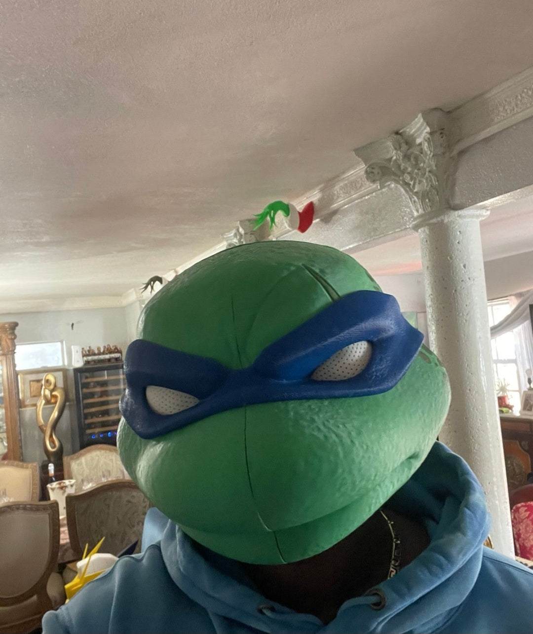 TMNT Leonardo helmet mask with magnetic closures and white eye details, one size fits most adults up to 24 inches head circumference