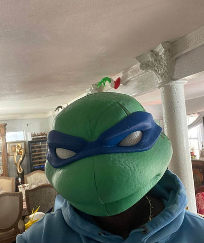 TMNT Leonardo helmet mask with magnetic closures and white eye details, one size fits most adults up to 24 inches head circumference
