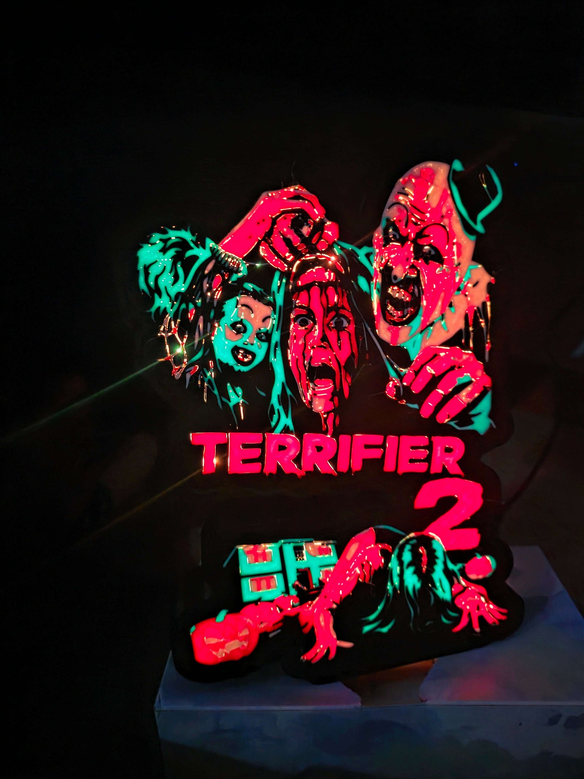 Terrifier 2 art clown lightbox with red blue white and black colors