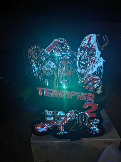 Terrifier 2 art lightbox featuring the clown in red, white, grey, and black colors