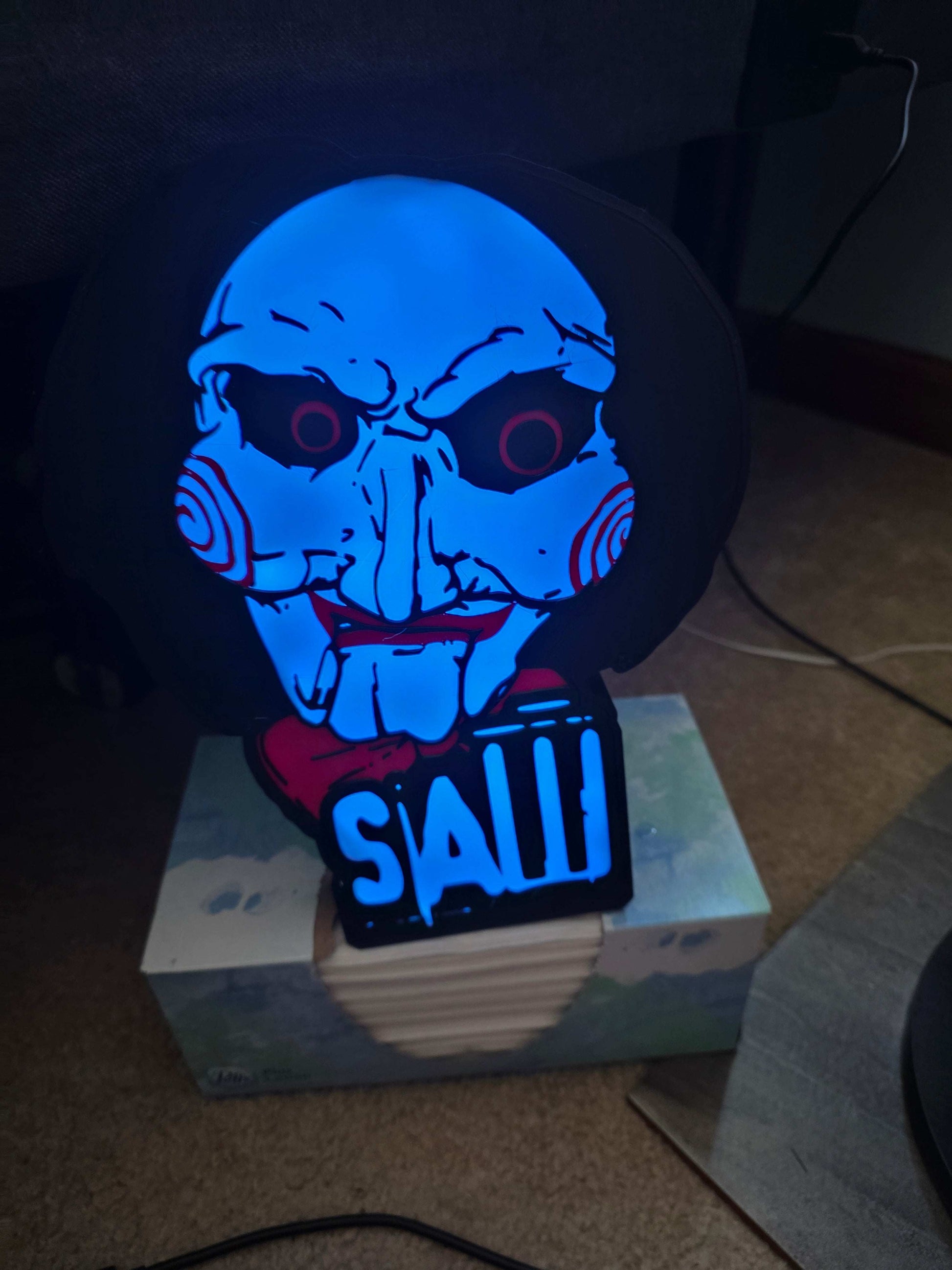 10-inch saw lightbox with horror icon design, ONN LED lighting, and remote control, creating a dynamic mood centerpiece