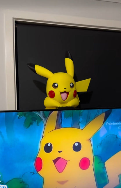 Pikachu screen buddy with stand pieces mounted on full-size TV