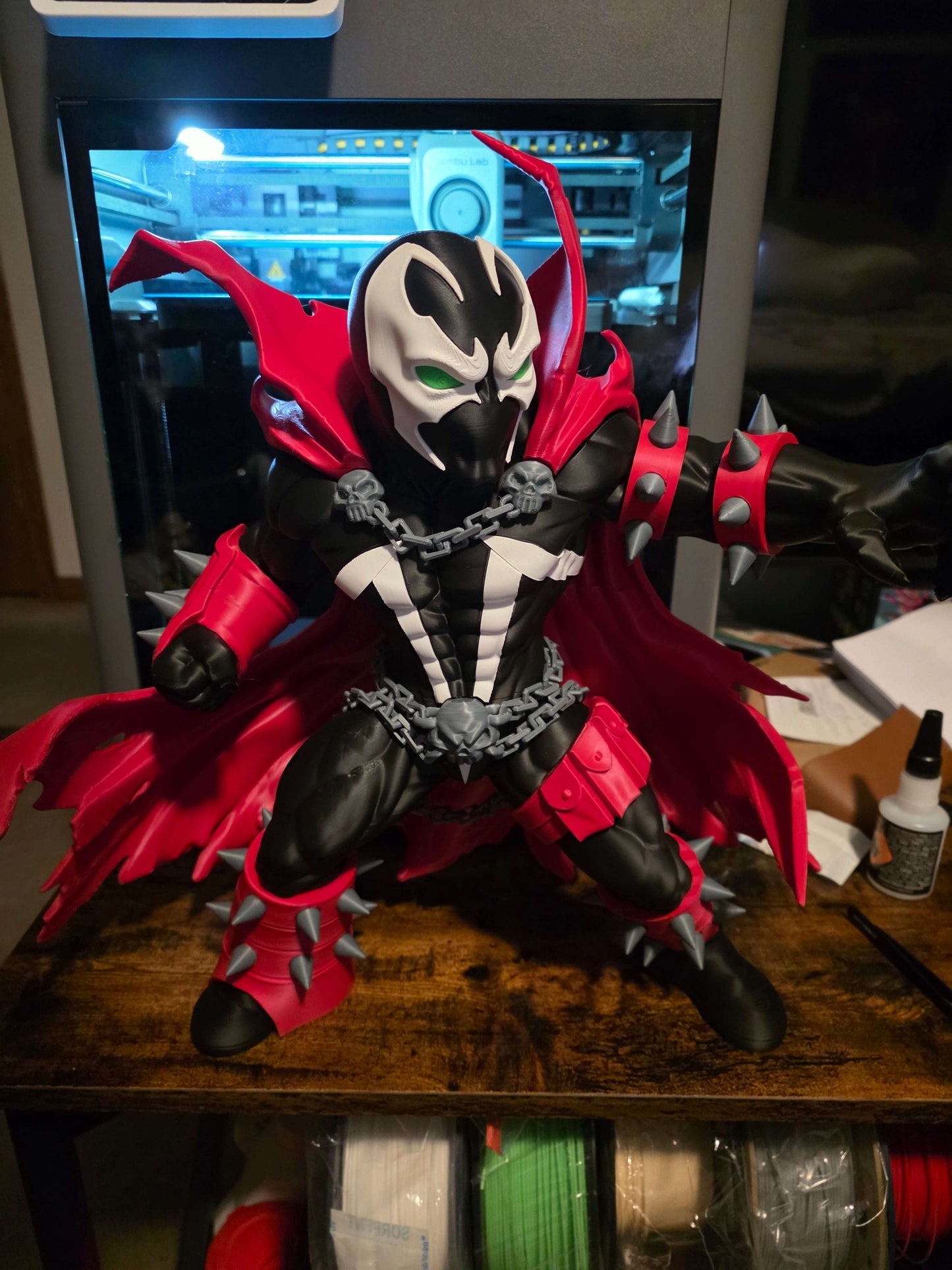 16-inch Spawn figure collectible with customizable grey or neon green chains and detachable cape pieces for display