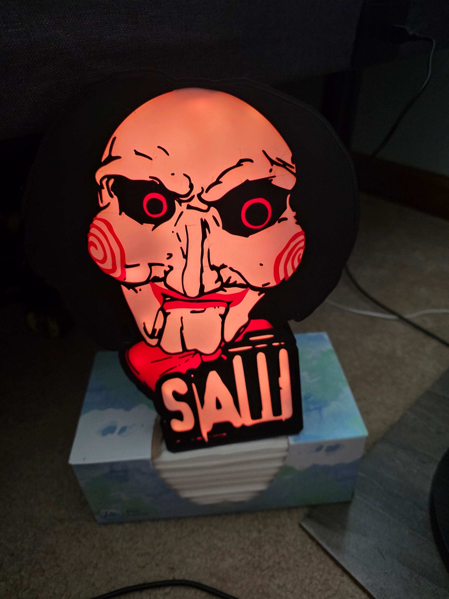 10-inch saw lightbox with horror icon, ONN LED illumination, and remote control, creating dynamic ambient lighting