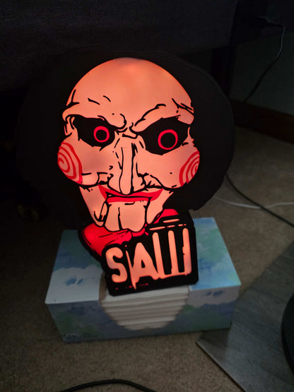 10-inch saw lightbox with horror icon, ONN LED illumination, and remote control, creating dynamic ambient lighting