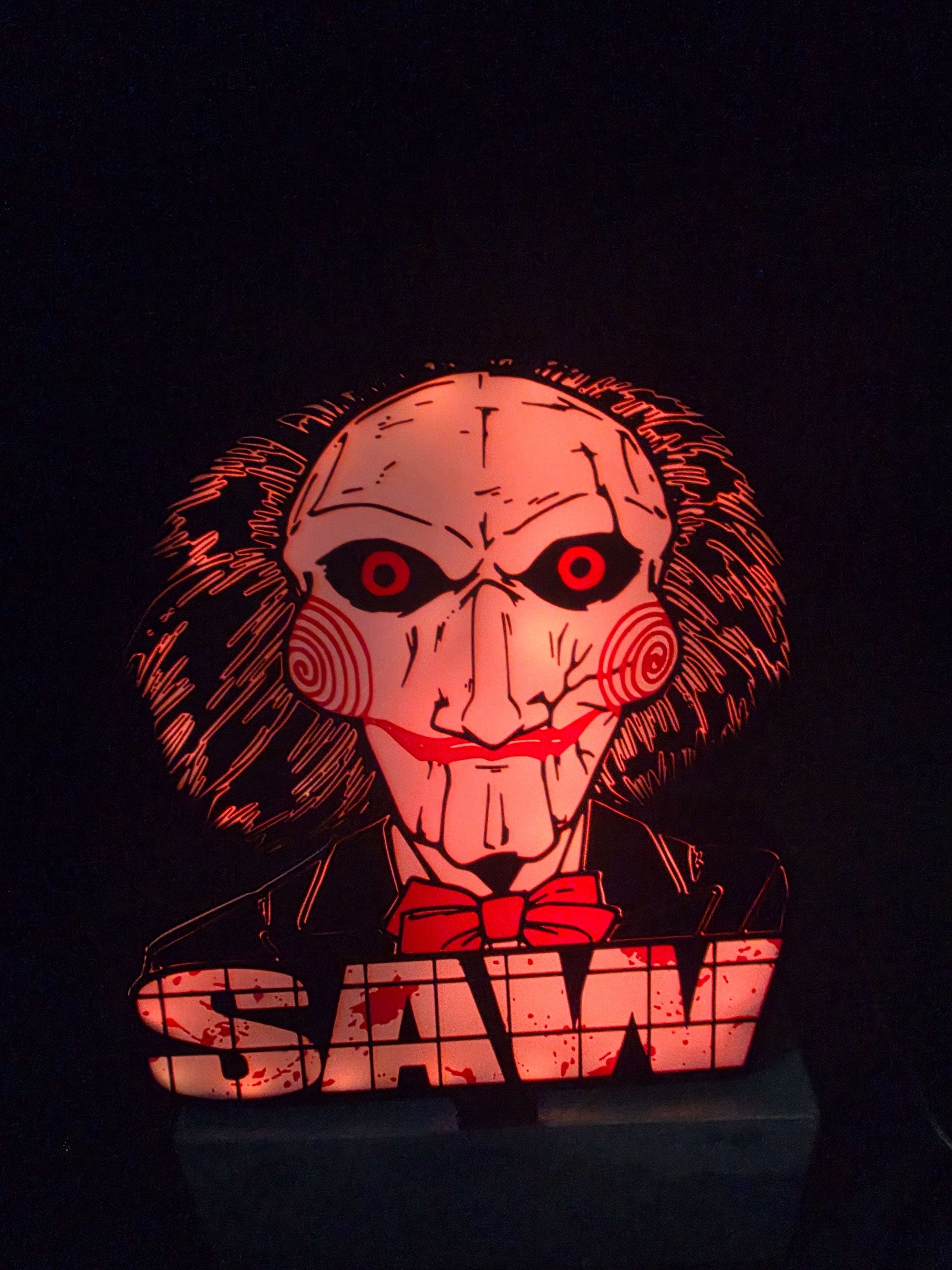 Large saw lightbox featuring Onn LED Billy the Puppet horror theme