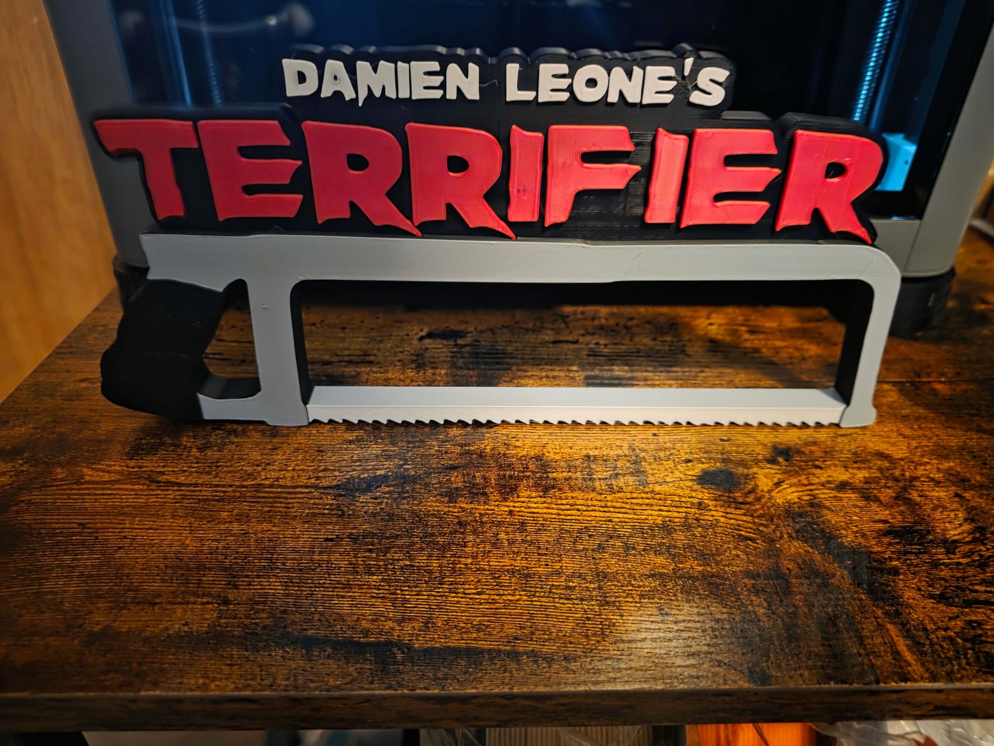 12-inch Terrifier horror logo prop featuring Art the Clown white saw design ready to ship