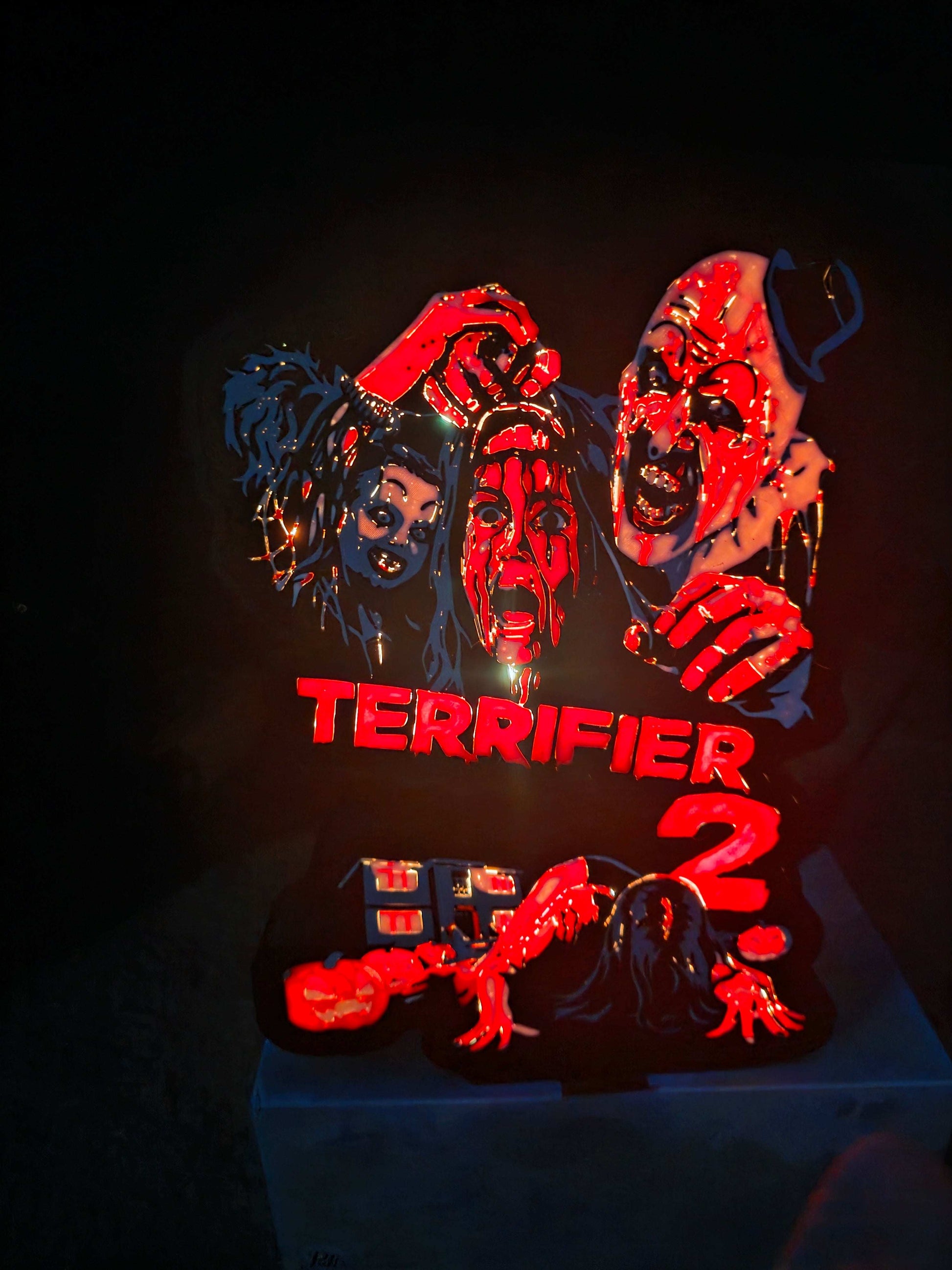 Terrifier 2 art lightbox featuring the clown in red white grey and black colors