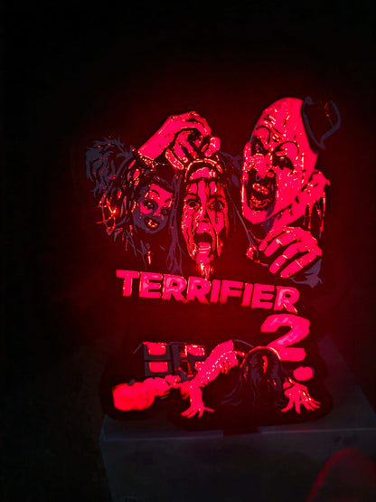 Terrifier 2 art of The Clown in red, white, grey, and black lightbox