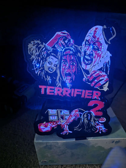 Terrifier 2 lightbox art featuring the clown in grey, white, red, and black colors