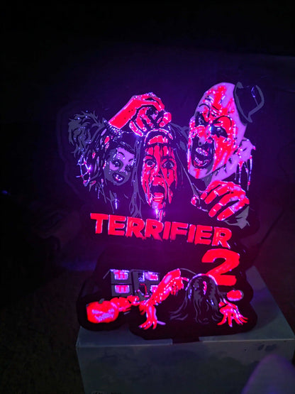 Terrifier 2 lightbox art featuring the clown in red, white, grey, and black colors