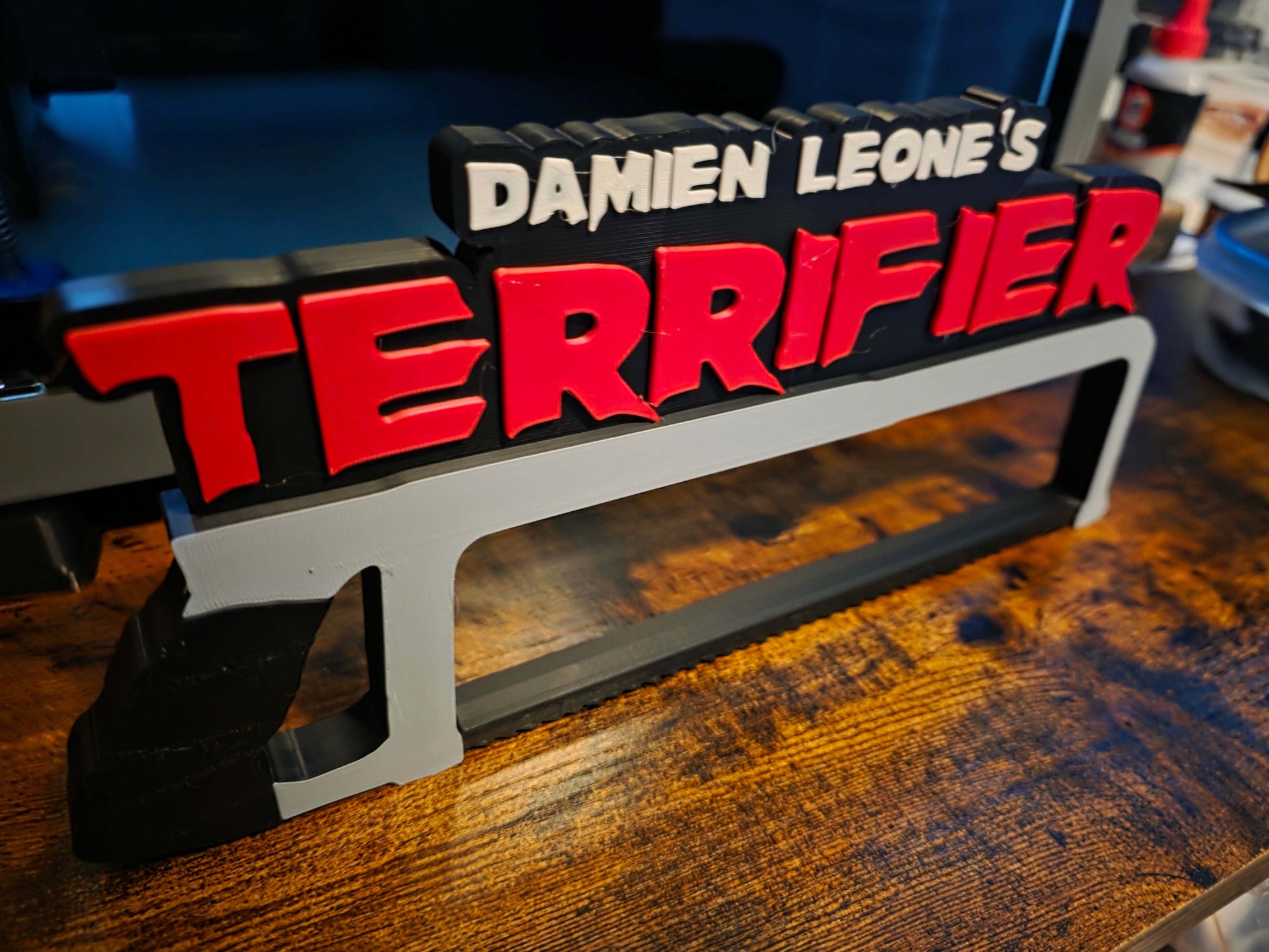 12-inch Terrifier art featuring The Clown horror logo with black saw motif on black background