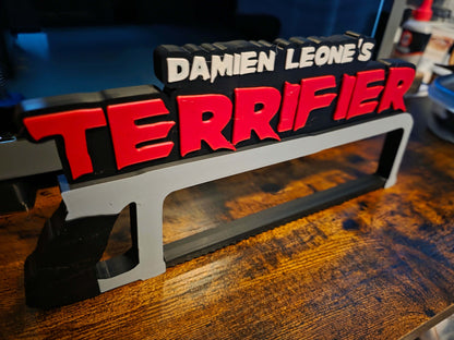 12-inch Terrifier art featuring The Clown horror logo with black saw motif on black background