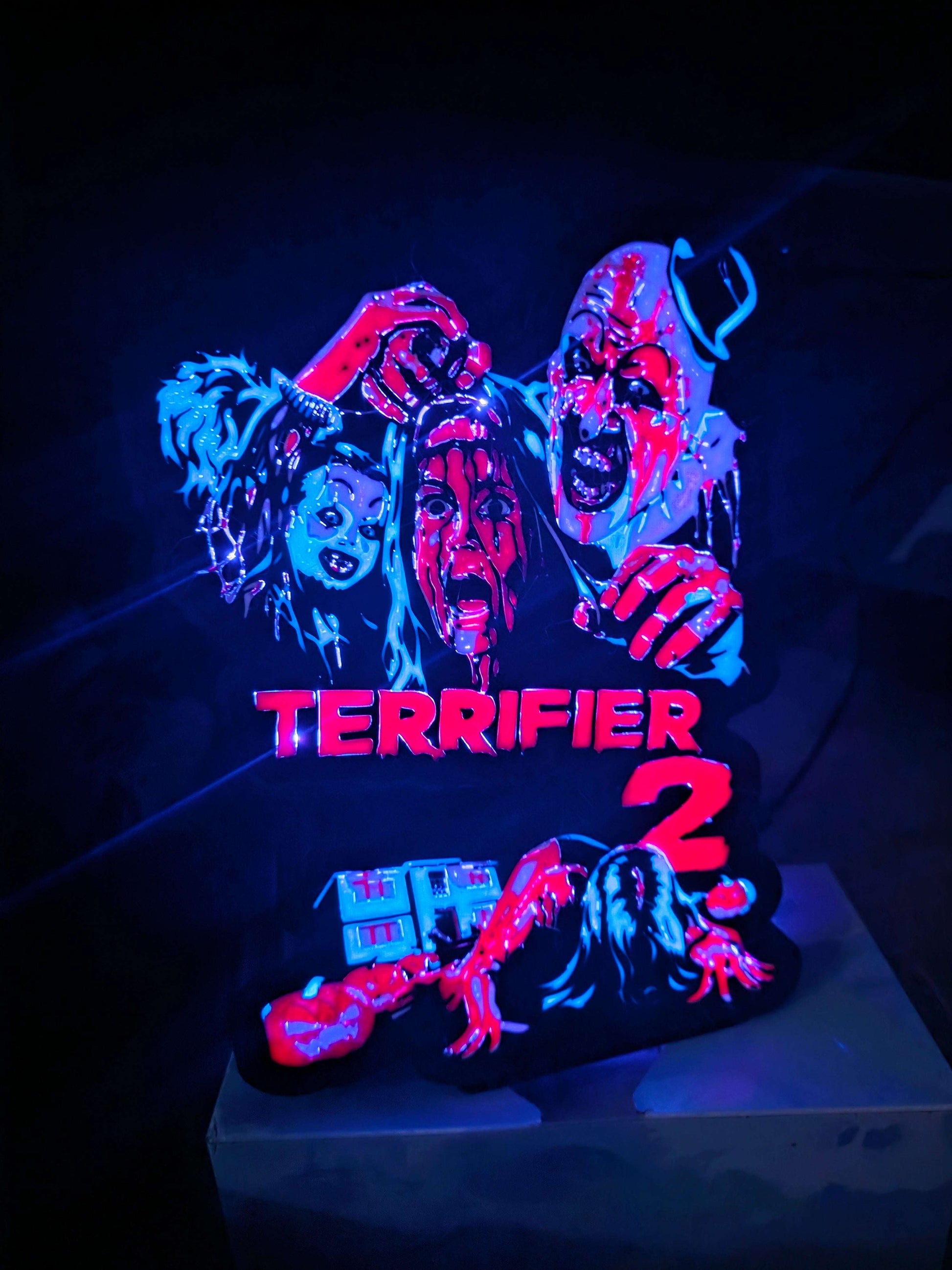 Terrifier 2 art of The Clown in blue red white black lightbox